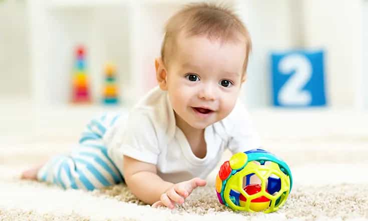 a baby playing with a ball