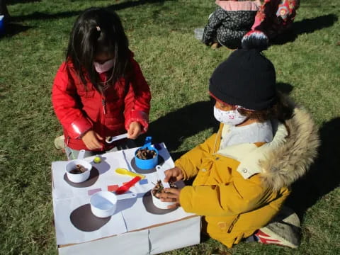 a person and a child sitting at a table with food