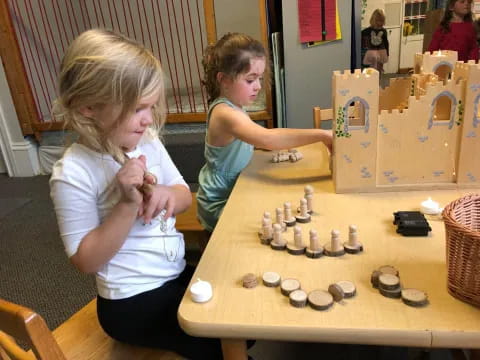 a couple of girls playing chess