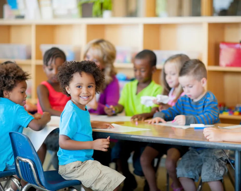 a group of children sitting at a table