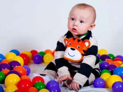 a baby in a ball pit