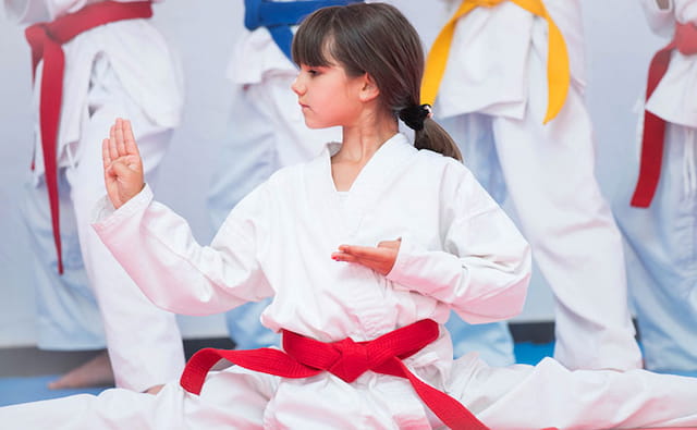 a woman in white karate uniform