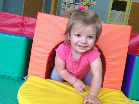 a child sitting in a ball pit