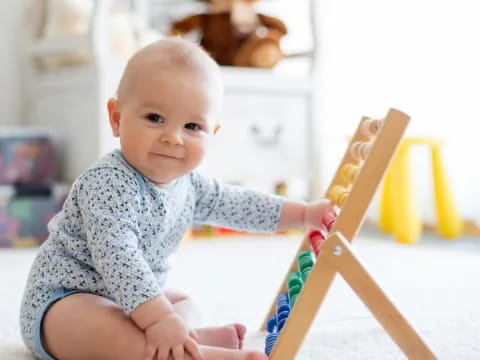 a baby sitting on a wooden chair