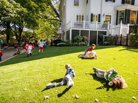 a group of people playing in a yard