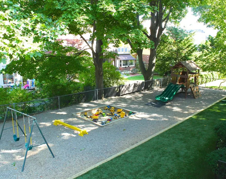 a playground with a slide and trees