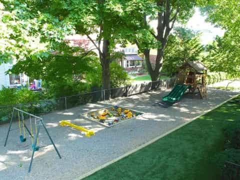 a playground with a slide and trees