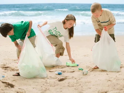 a group of people playing with sand on a beach