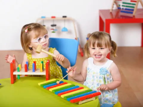 a couple of young girls playing with toys in a room