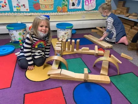 children playing with wooden blocks