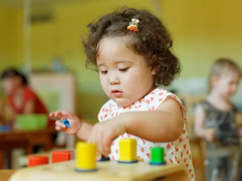 a young girl playing with toys