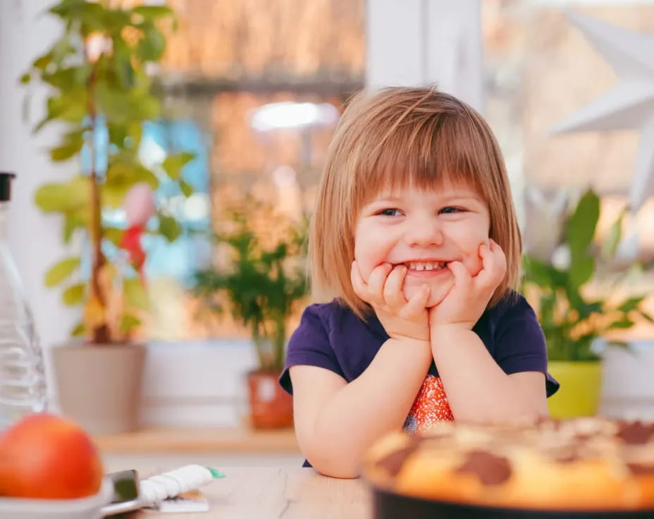 a little girl eating a cake