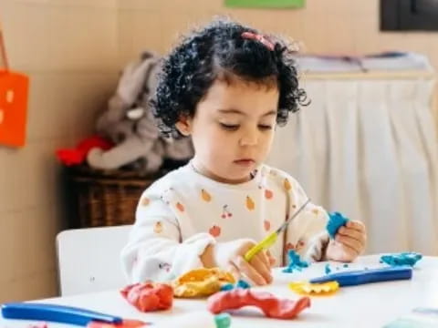 a baby sitting at a table