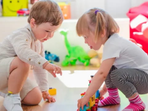 a couple of children playing with toys