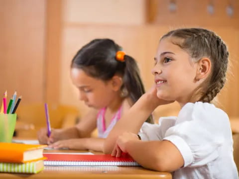 a young girl and a young girl studying