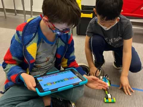 a few boys playing with a toy