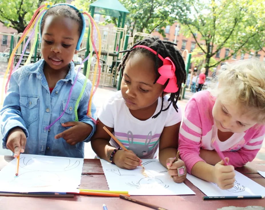 a group of children sitting at a table