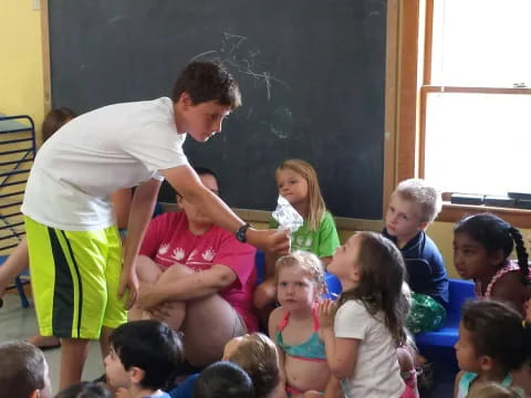 a man teaching children in a classroom