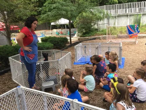 a person standing in front of a group of children