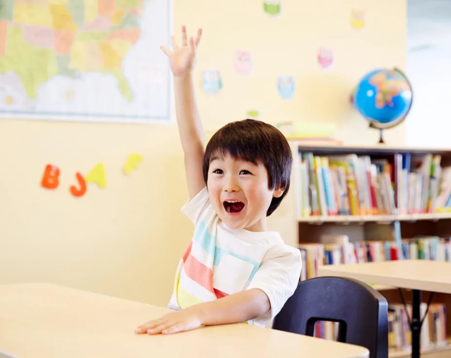 a boy raising his hand