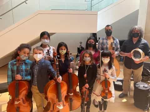 a group of people wearing masks and playing instruments