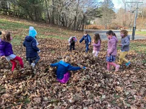 a group of children playing in a field