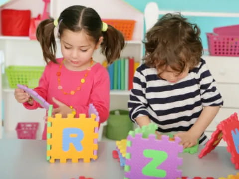 a couple of young girls playing with toys