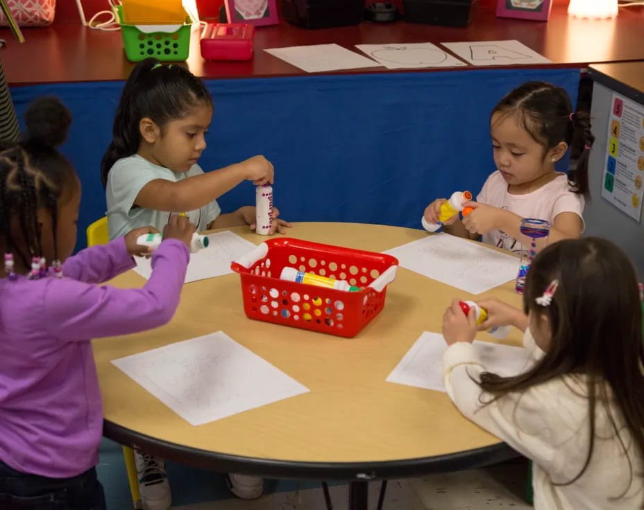 a group of children sitting at a table