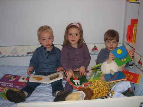 children sitting on a bed