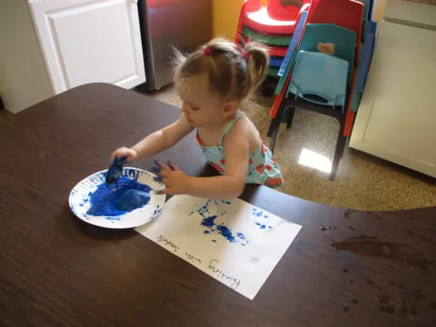 a little girl eating cake