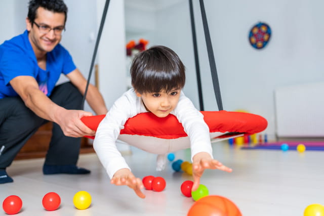 a person and a child playing with balls