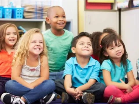 a group of children sitting in a classroom