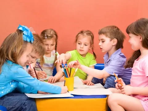 a group of children sitting at a table