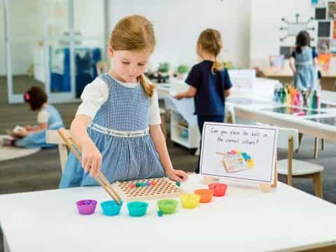 a young girl painting on a table