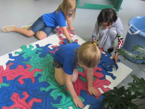 a group of children playing on a rug