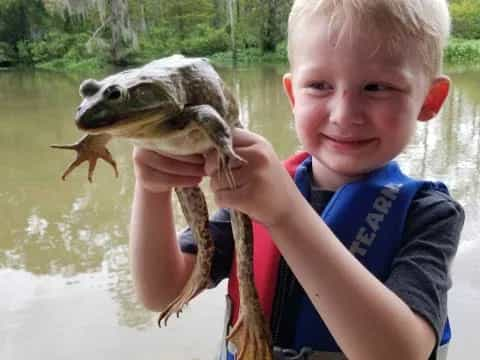 a boy holding a fish