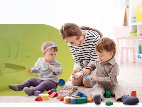 a person and two children playing with toys on the floor