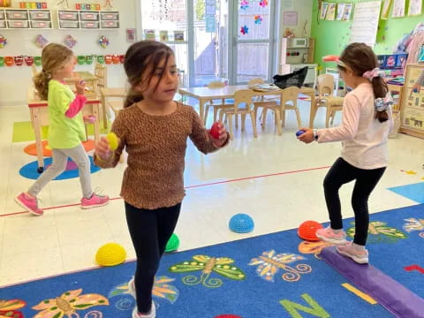 a group of children playing in a room with balloons