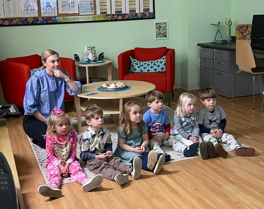 a group of children sitting on the floor