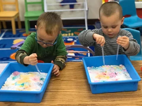 two boys playing with toys