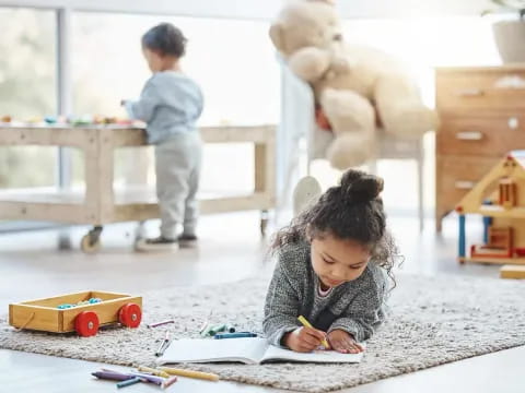 a young girl writing on a paper