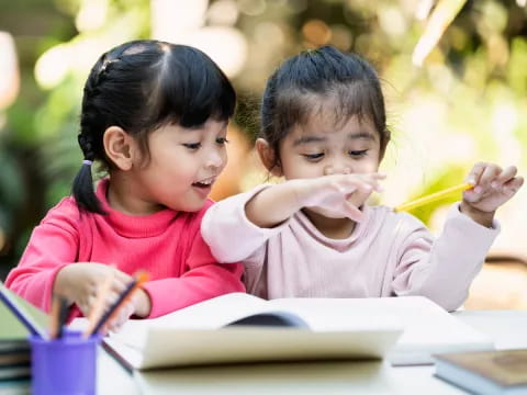 a couple of young girls studying