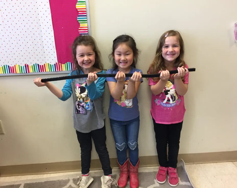 a group of girls holding up their hands