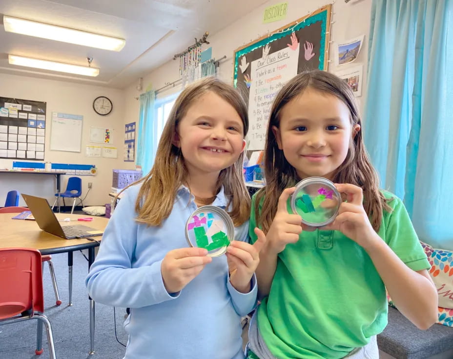 a couple of girls holding a toy