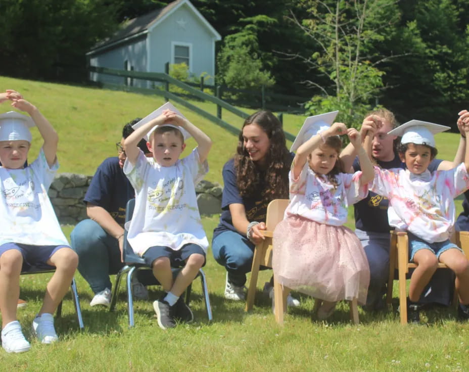 a group of people sitting on the grass