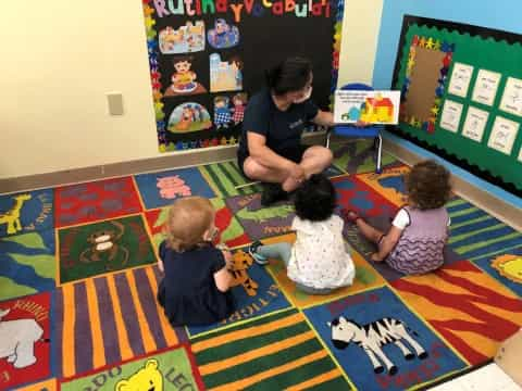 a person and several children sitting on the floor