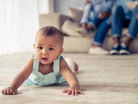 a baby crawling on the floor