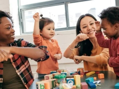 a group of people smiling and playing with toys