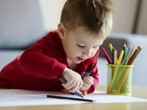 a child writing on a piece of paper