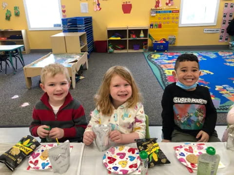 a group of children sitting on the floor with toys